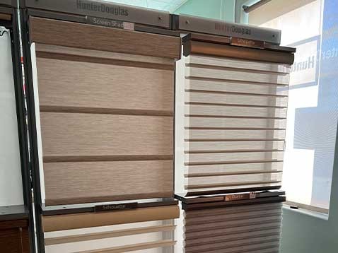 A display of four different Hunter Douglas window coverings